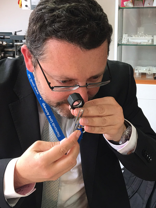 Diamond Specialist, Henri Keesje is using a Loupe Eyeglass Magnifier to inspect the diamond clarity