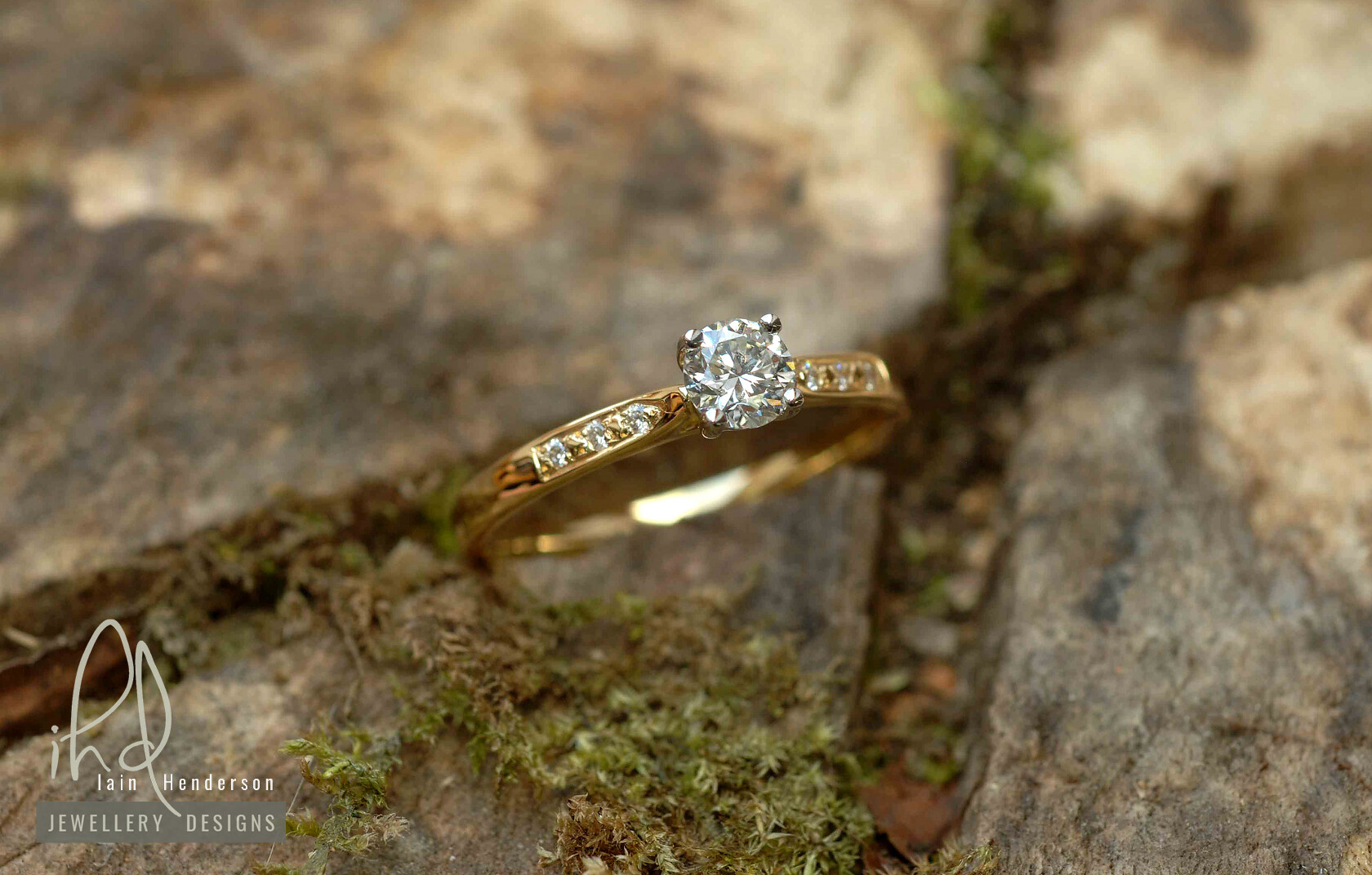 Vintage style yellow gold engagement ring with diamonds in the shoulders