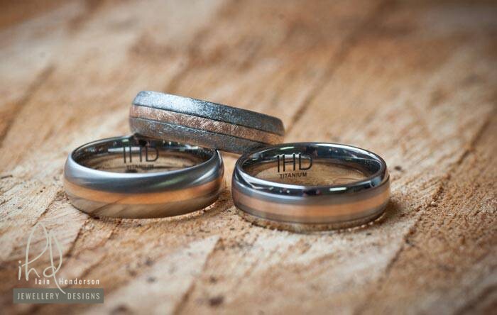 Titanium mens wedding rings with a rose gold inlay and various finishes