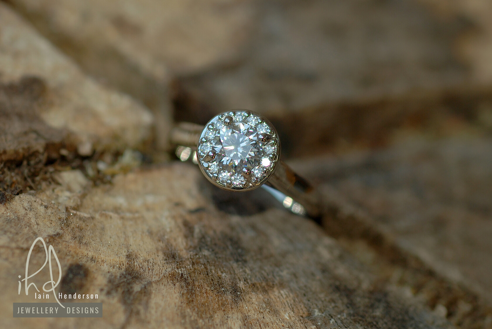 Halo style engagement ring with round diamonds